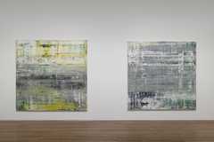 Two square paintings hung side by side on a white wall.